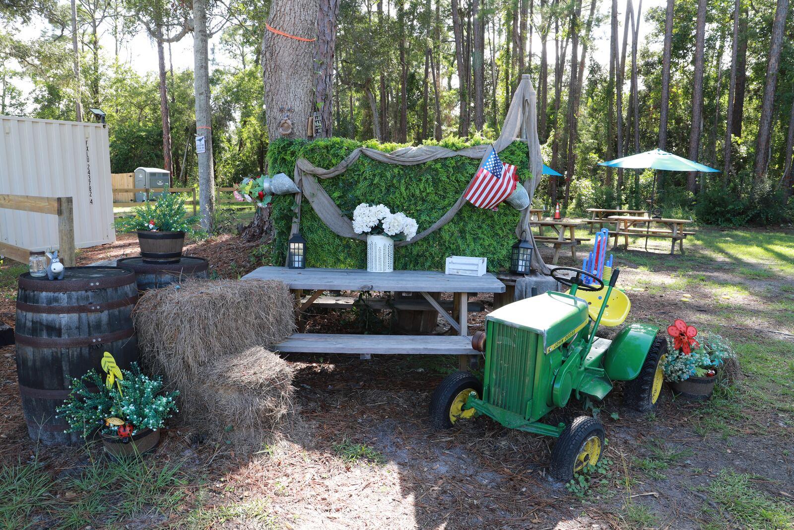 A decorated gathering corner and picnic tables at The Outpost